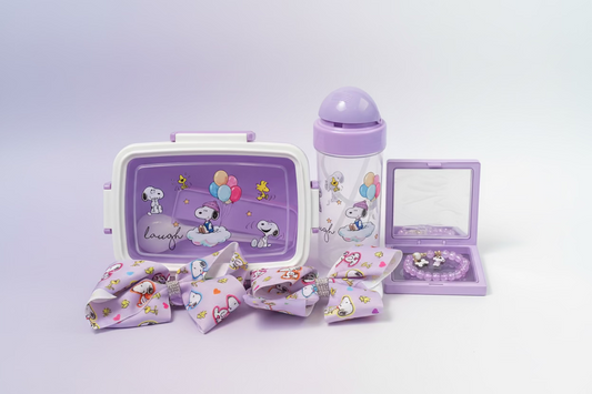 A coordinated pastel purple and pink Snoopy-themed accessory set including a lunchbox, tumbler, bracelet, and two fabric hair bows with cartoon prints.